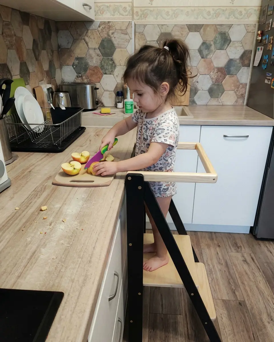 Barin Toys review of a modern black wooden learning tower with a natural wood step and compact foldable design